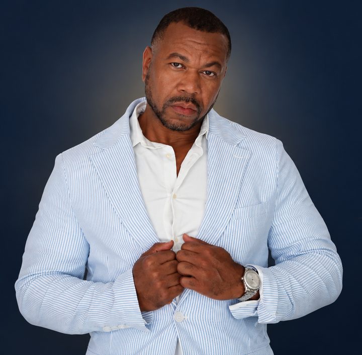 Dee Green, Wealth Coach, in a light seersucker blazer